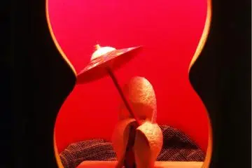 <p>A small figure in a bamboo luminary</p>