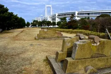 <p>The canon ruins at The Third Daiba, or Daiba Park, with the majestic Rainbow Bridge in the background</p>