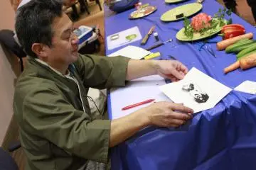 Chef Sato finishing one of his paper butterflies. All his designs are extremely detailed and are cut using kitchen knives. &nbsp; (Photo: Stephanie Fiorello)