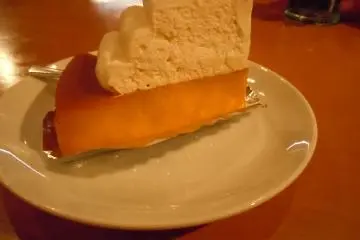 <p>My husband's dessert: rich, sweet, Japanese version of pumpkin pie topped with cream (250 yen). I think I might opt for that next time. I ordered cheesecake (270 yen) which was good, but needed fruit or some other flavor besides sugar. What a great big dose of sugar! We refreshed after dessert with a glass of water</p>