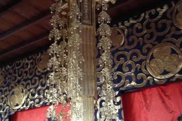 <p>An elegant gold-plated decoration hanging in front of the chanting table</p>