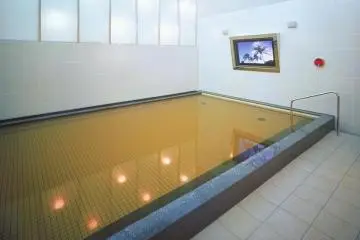 <p>A view of the onsen with the big screen TV to enjoy while you soak in the natural hot waters.</p>