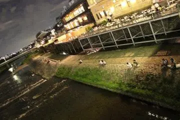 During summer time, couples can often be seen sitting, dotted along the riverbank, as in this typical night view along the Kamogawa river