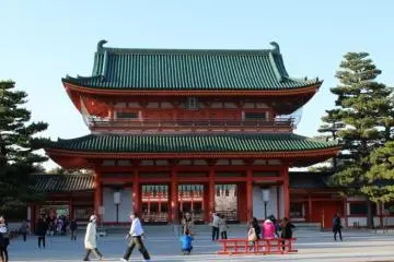Visitors pass through a side gate alongside Oten Gate, an important cultural heritage asset of Japan