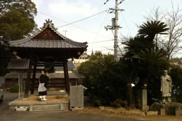 The priest ringing the temple bell