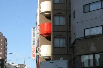 <p>Across the street from the giant chef is a building whose balconies are teacups.</p>