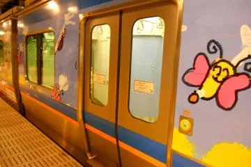 Cute characters drawn on the train. The door opens/closes by pushing the button beside it to save energy