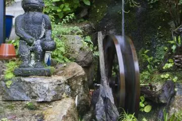 <p>At the restaurant's entrance: the statue to the left of the waterwheel is a mythical creature known as a kappa</p>