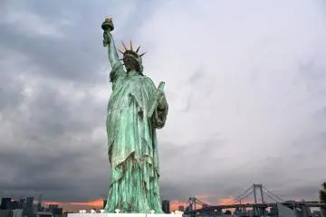 <p>The Statue of Liberty and Rainbow Bridge at sunset.</p>