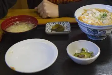 <p>Oyako-don teishoku: a rice bowl topped with chicken and egg, served with vegetables, pickles, and miso soup</p>