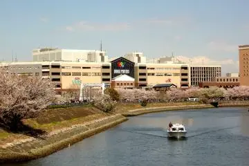 <p>World Porters shopping mall beyond the line of cherry blossoms</p>