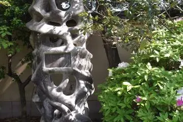 <p>A monument in the shade of the trees alongside the main path</p>