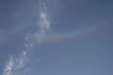 <p>Looks like a rainbow, but it's a halo; not a raincloud in the sky</p>