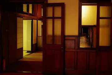 Inside Rokkaen, western influence, with tatami mats and paper screens.