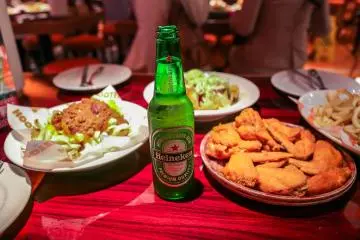 <p>The food menu includes appetizers (wings, salads, nachos) sandwiches, ribs, seafood and more. Drinks include beers, margaritas, cocktails. Shot girls walking around as well with various shooters.</p>