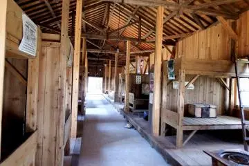 <p>Inside the 1st Baracke (Barack). Bunk beds line both sides</p>