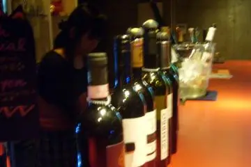 More wine on the bar (or possibly the same wine from a different angle)