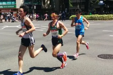 <p>Runners emerge from the Japanese zelkova&nbsp;tunnel into the unforgiving sun.&nbsp;</p>