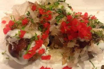 Watch the bonito flakes unfurl like live embers dancing on top of the takoyaki