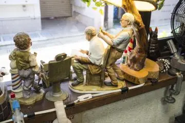 <p>Barber figurines sitting on the window display.</p>