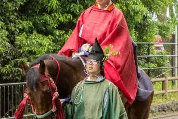 <p>This stern looking man on horseback is a Kurazukai（内蔵使). He is a courtier carrying a scroll to be read by the Imperial Messenger.</p>