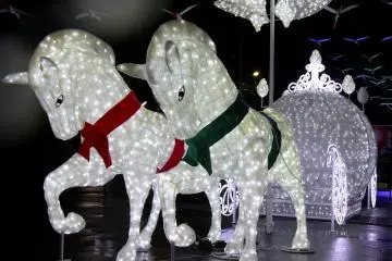 <p>A beautiful horse drawn carriage welcomes you to the illuminated walkway.</p>