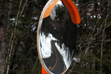 <p>Reflection of the winding road through the mountains and hills near the cave.</p>