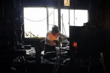 <p>Mr Shimizu Masaji&nbsp;braving the heat of the flames to ensure the metal is heated up enough to be molded.</p>
