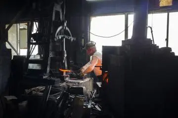 <p>Mr Shimizu Masaji hard at work, pounding a blade away.</p>