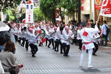 Suzume Odori groups dance down the covered arcades to bright, cheerful music.