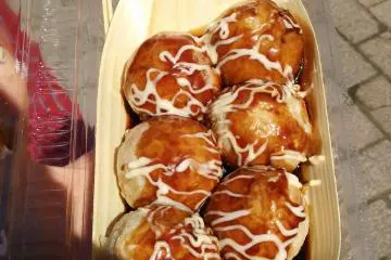 Dozens of food stalls sell all sorts of food. There's local food and festival food and takes on a favorite, like these quail's egg takoyaki.