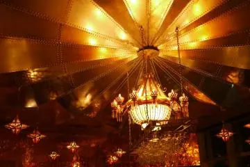 <p>The beautiful ceiling illuminated with a golden chandelier.</p>