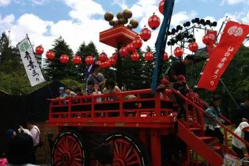 An empty float is swarmed by children ordered by their parents to pose for a souvenir picture.