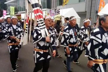 A firemen's association in traditional ware make their way through the crowd.&nbsp;