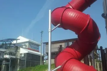 <p>Slide in the playground with cable car to GALA behind</p>