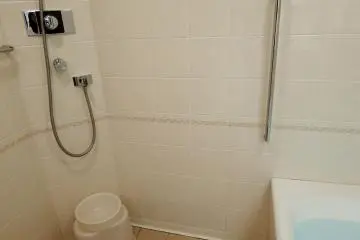 <p>Bathroom has a shower on the side with wash bowl and small chair. Japanese style!</p>