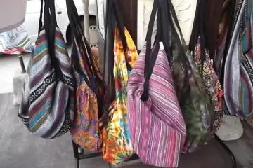 <p>A rail of bags outside the main store</p>