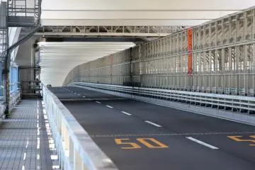 <p>Cars have their own lanes, as do pedestrians who walk the bridge, and the trains are also on the same level on the right side.&nbsp;</p>