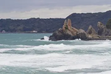 <p>Tategami Rock looks over Minatohama's sandy beach</p>