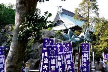 <p>Dragon statue surrounded by purple banners</p>