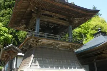 <p>A frontal view of one of the smaller structures with a bell. To the side, there is a map showing an overview of the entire area. There are washrooms to the back.</p>