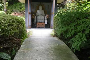 <p>This little bridge across a little pond takes you to this statue. It's almost hidden behind some trees so it's easy to miss.</p>