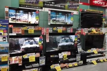 <p>A fraction of the TVs on display at an electronics store</p>