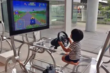 <p>Spotted this cute kid trying a driving simulator in one corner of the Nissan Gallery. There were a few terminals for kids to enjoy. Professional class driving simulators by game maker Polyphony Digital (Gran Turismo) also are set up in the gallery.&nbsp;</p>