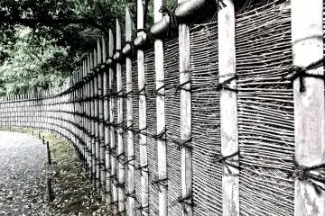 <p>An impressive bamboo fence lining the road to the villa</p>