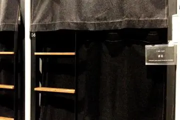 <p>Separate screened beds in the dormitory</p>