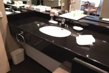 The dressing room is separated by a door from the bathroom