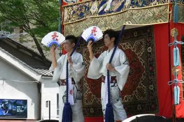 <p>Two men stood on the front of this float waving their fans around</p>