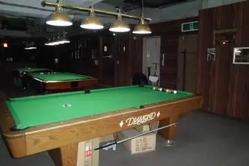 Three lush pool tables