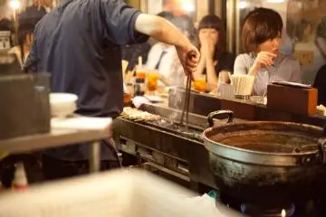 <p>A chef attending to his yakitori</p>